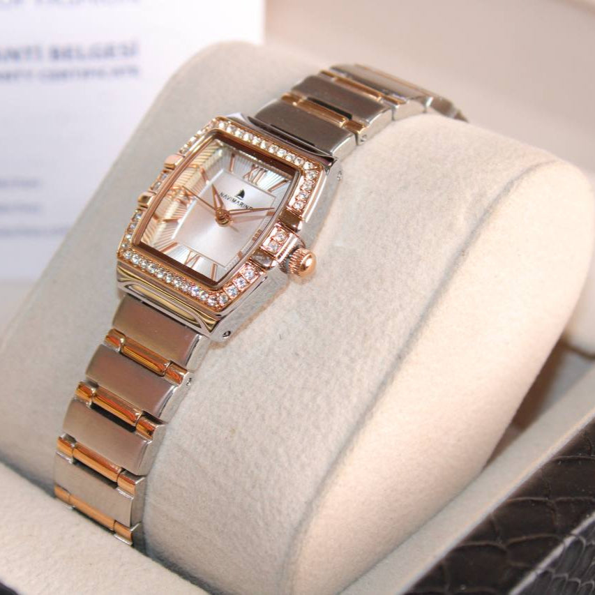 Luxury watch with rose gold and silver band on a white cushion