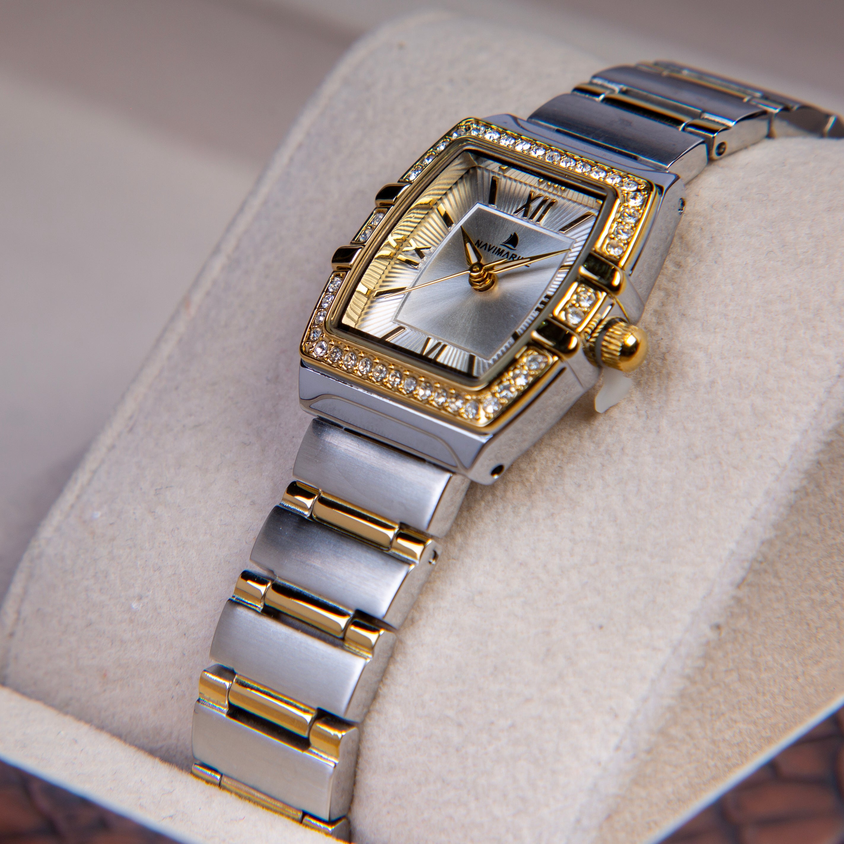 Luxury watch with silver and gold band on a soft surface