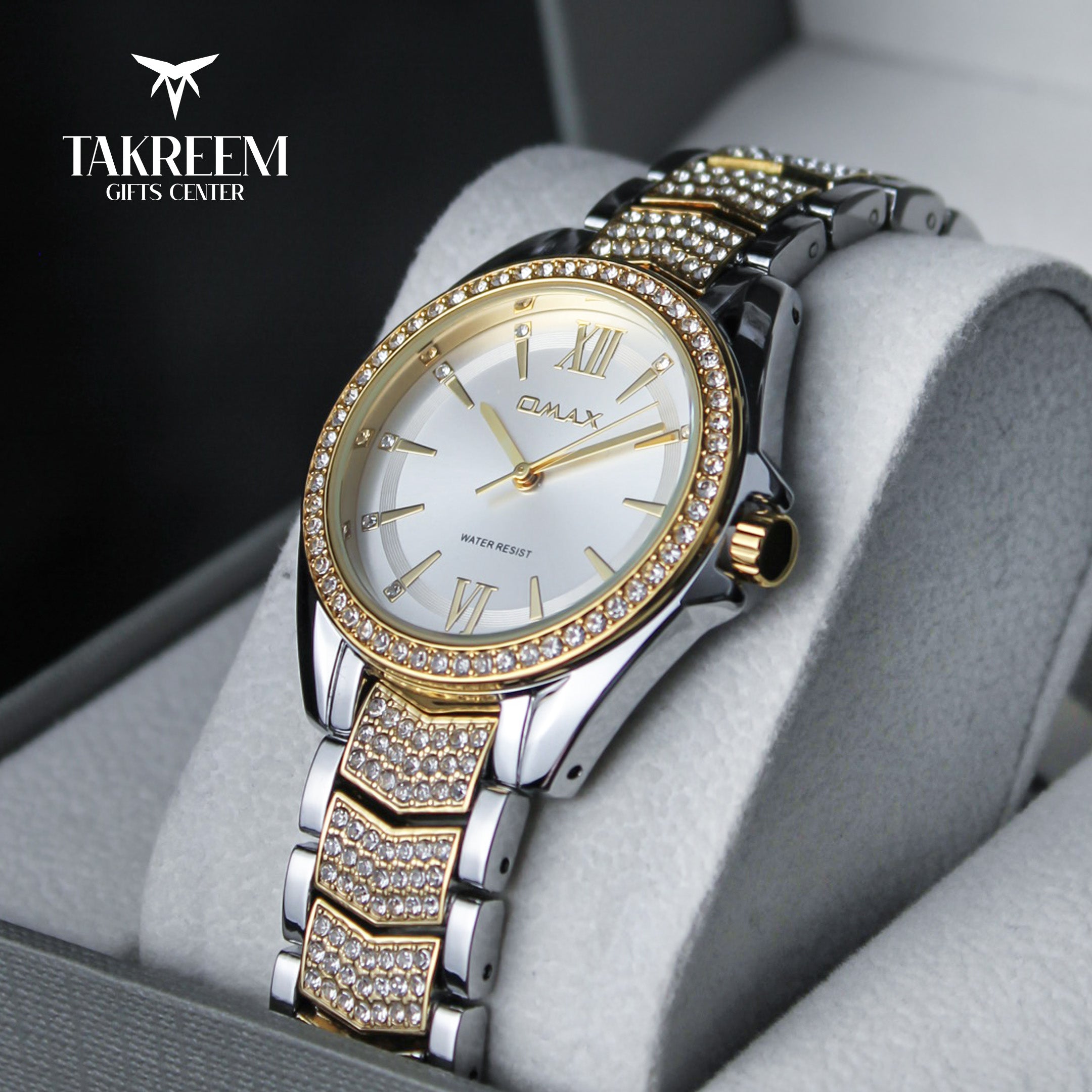Luxury watch with gold and silver band on a gray cushion, brand 'Takreem' visible.