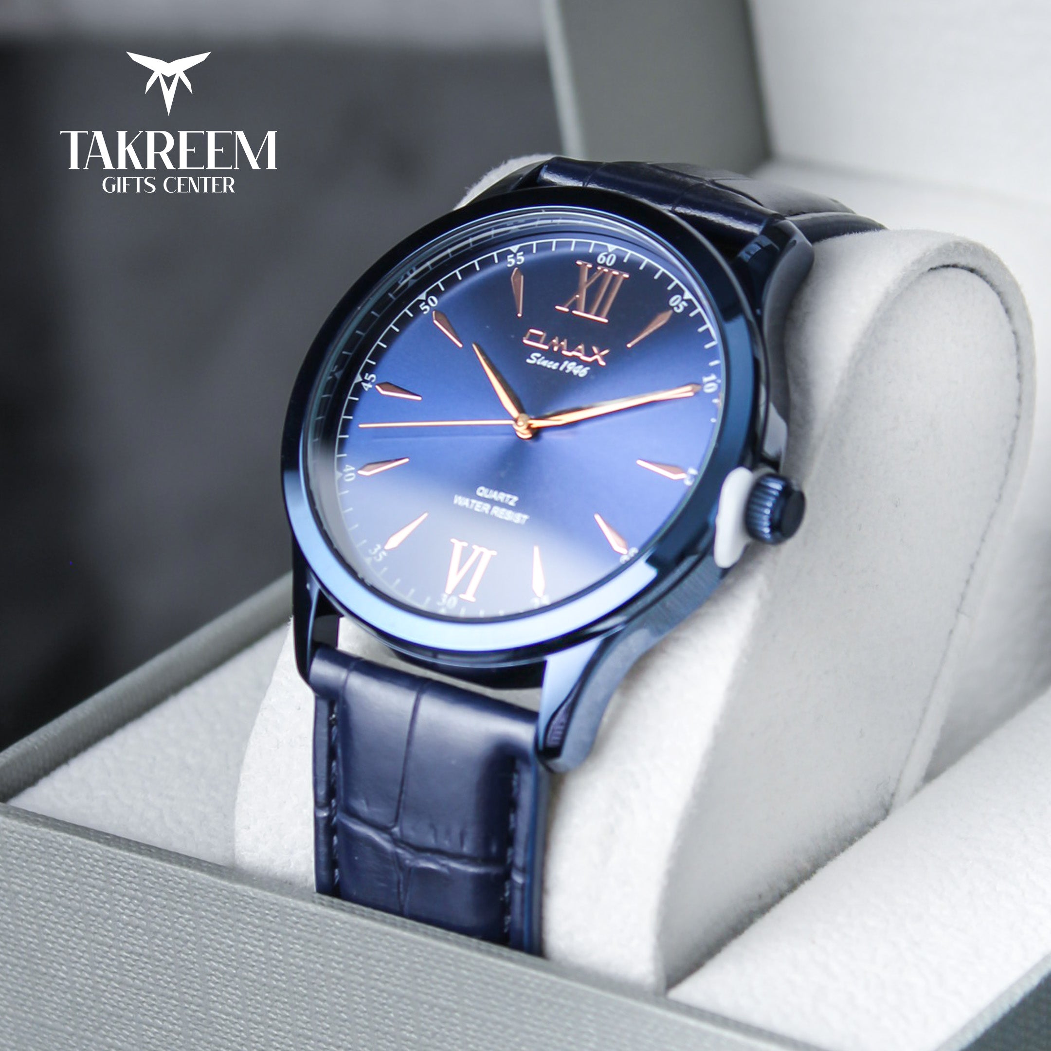 Blue wristwatch with a detailed face in a box, branded 'Takreem Gifts Center'.