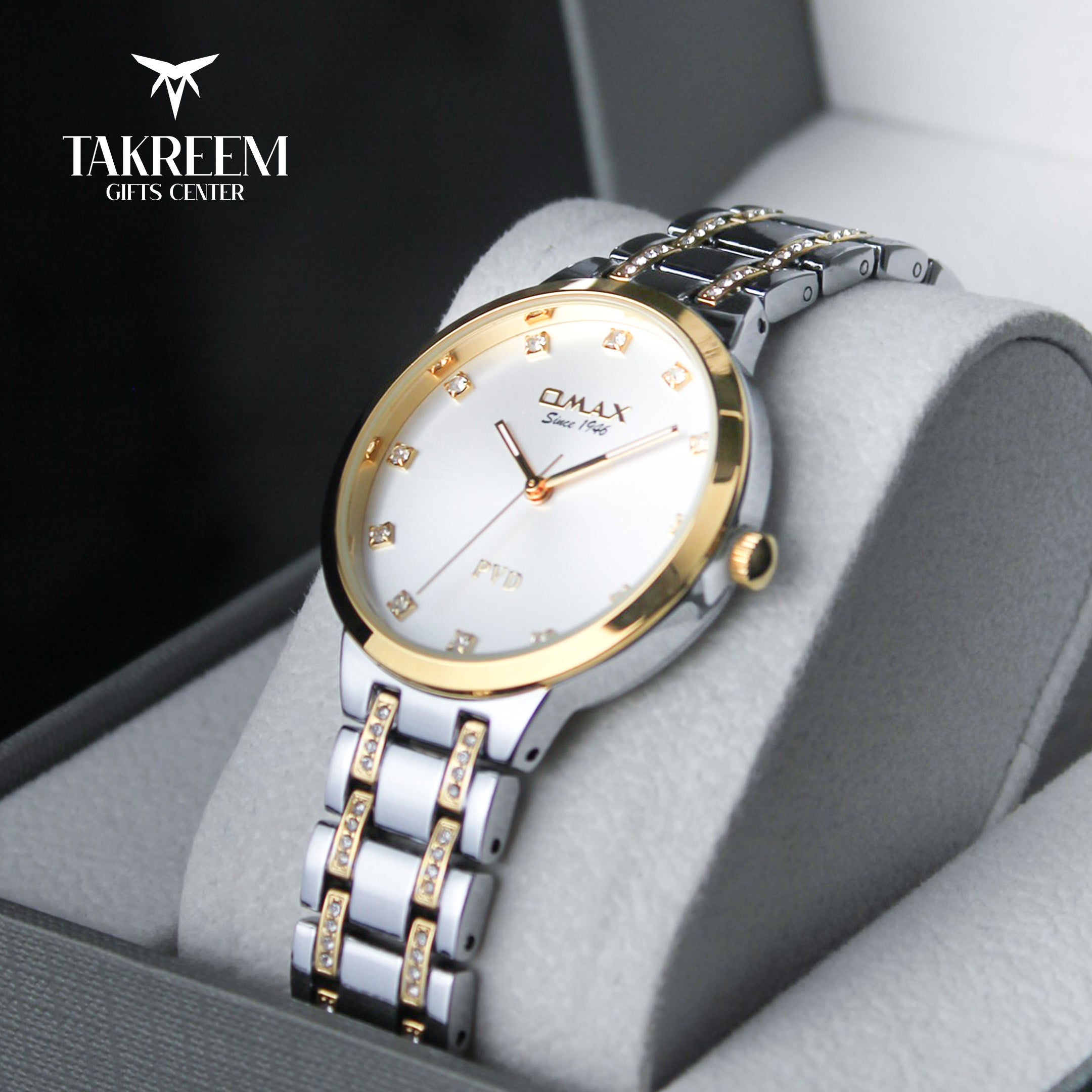 Luxury watch with gold and silver band on a gray cushion, brand 'Takreem' visible
