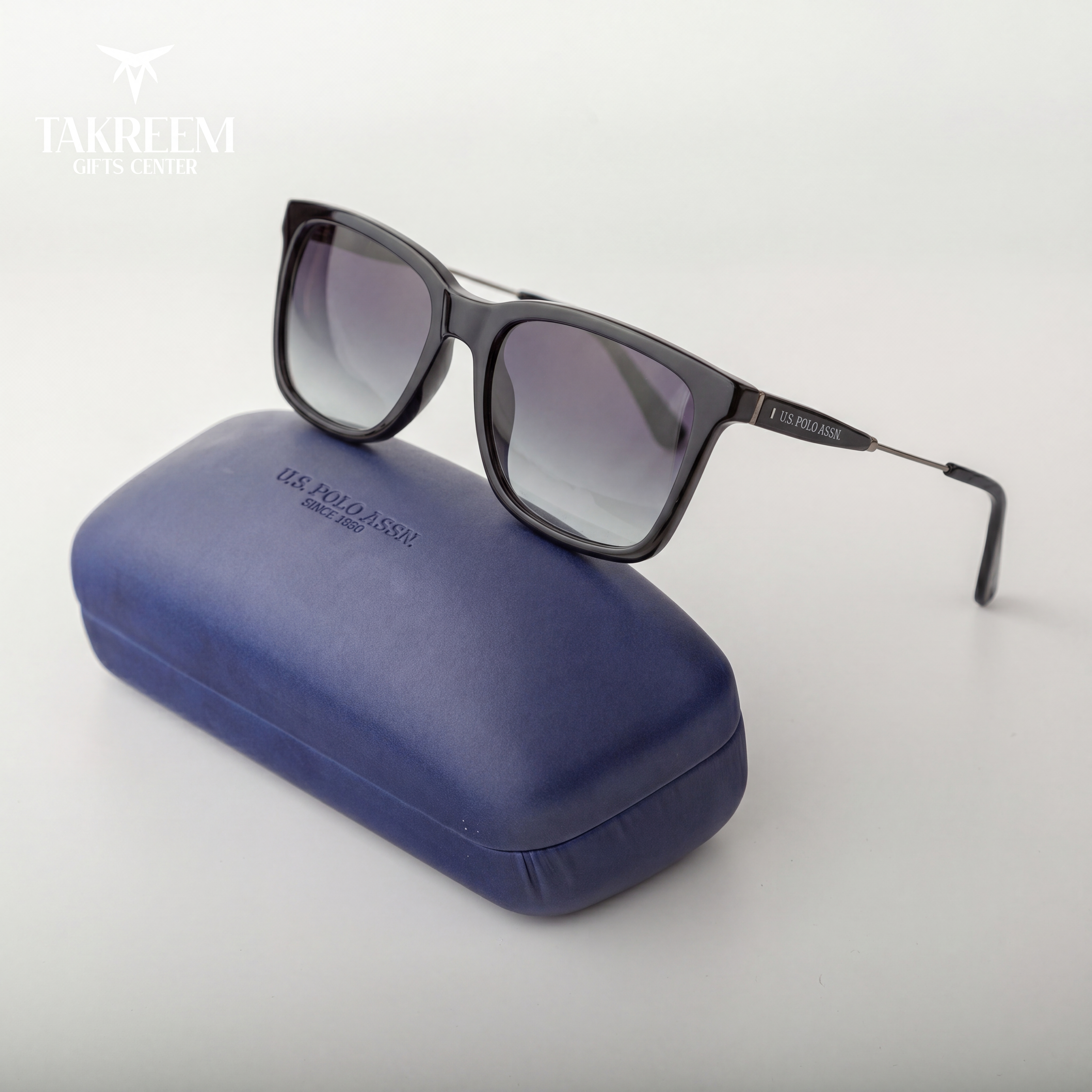 Sunglasses on a blue case with 'Takreem' branding on a white background