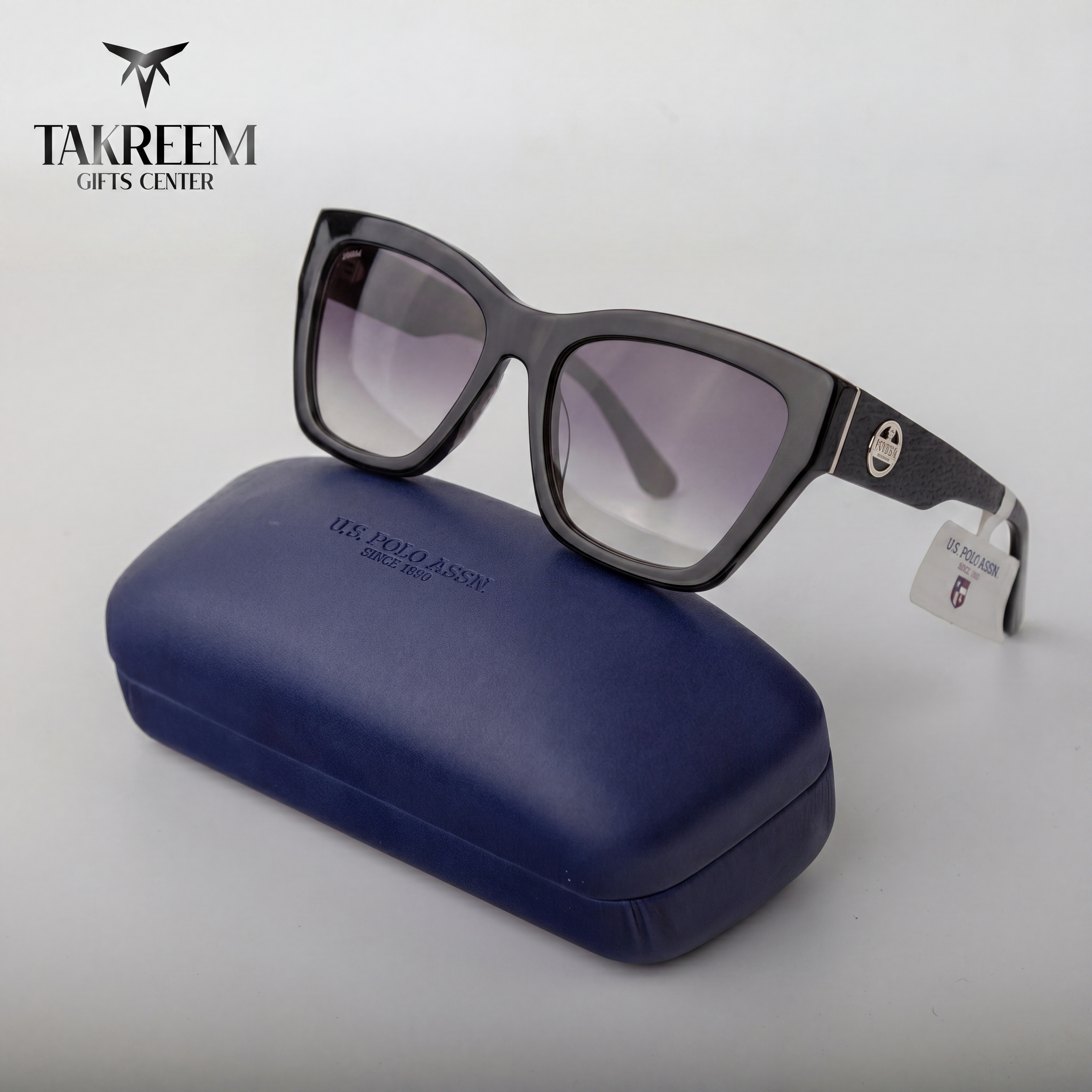 Sunglasses with a blue case on a white background, featuring the Takreem Gifts Center logo.