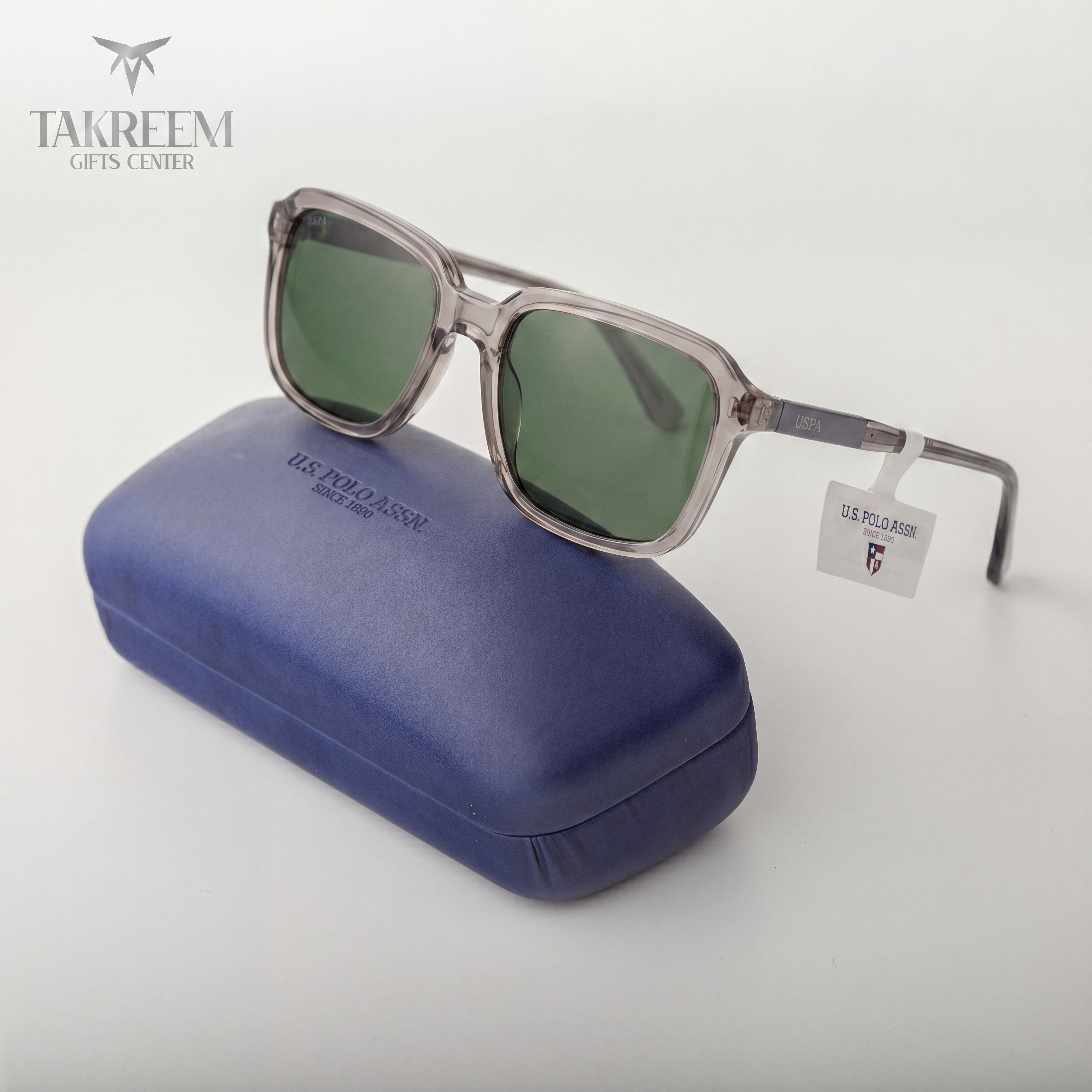 Sunglasses with a blue case and U.S. Polo Assn. tag on a white background