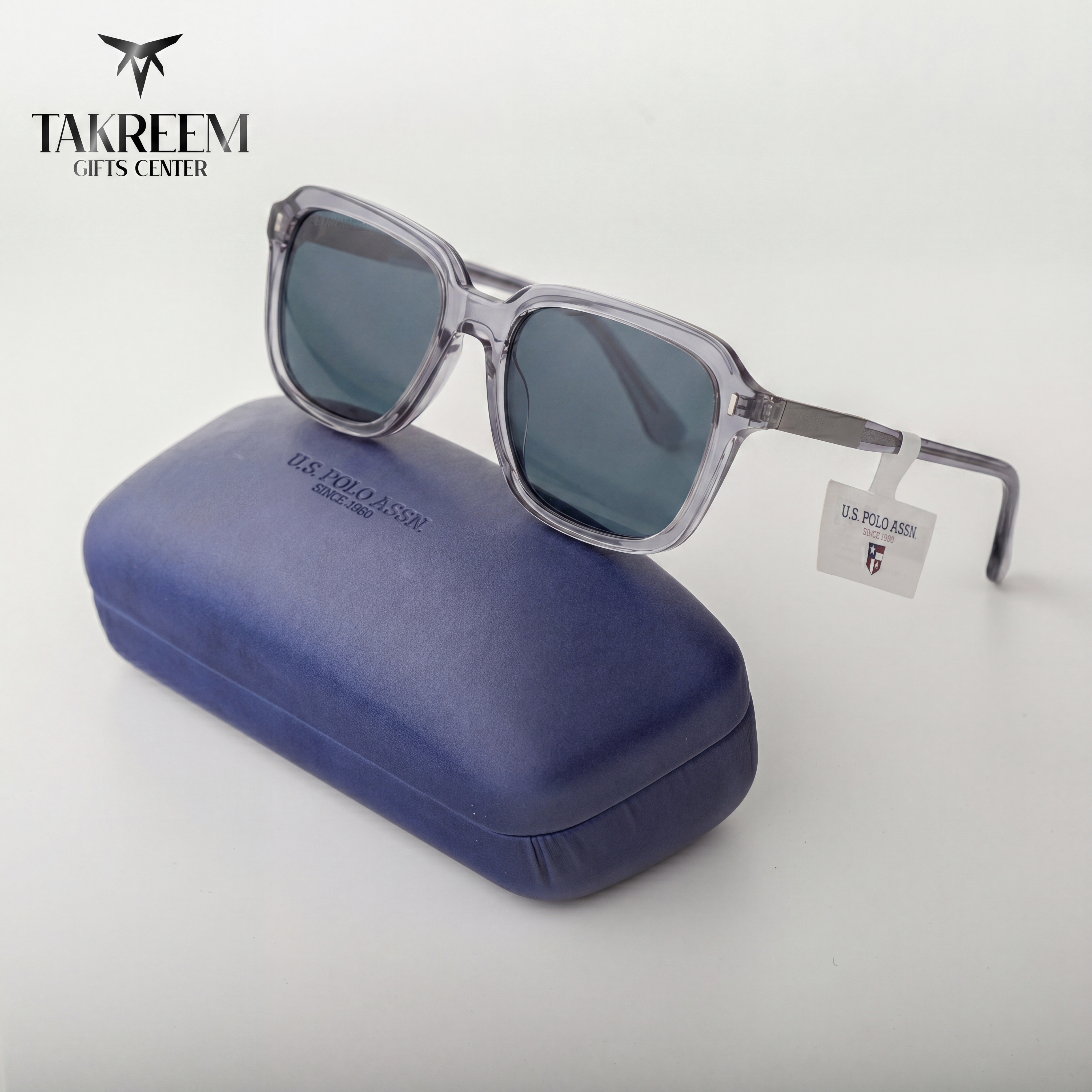 Sunglasses with a blue case on a white background, featuring the Takreem Gifts Center logo.