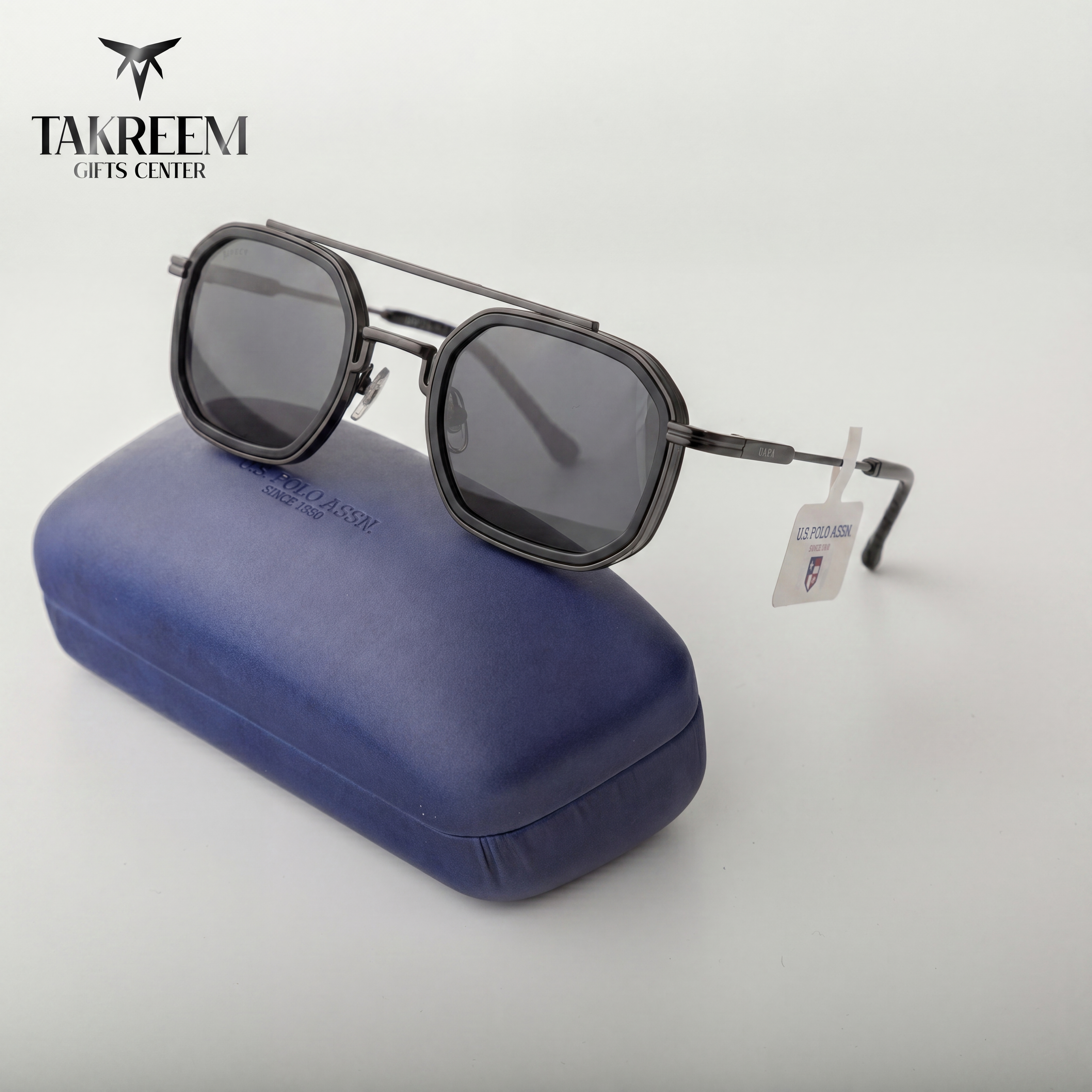 Sunglasses with a blue case on a white background, featuring the Takreem Gifts Center logo.